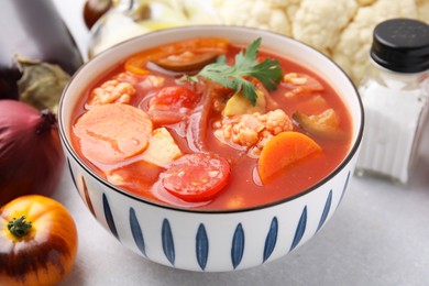 Photo of Tasty homemade stew with vegetables on white table, closeup