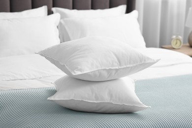 Many soft pillows on bed at home