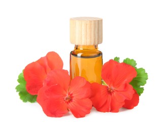 Photo of Bottle of geranium essential oil and beautiful flowers isolated on white