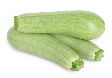 Photo of Many fresh ripe zucchinis isolated on white