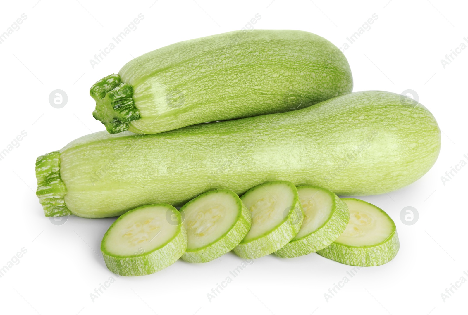 Photo of Fresh whole and cut zucchinis isolated on white