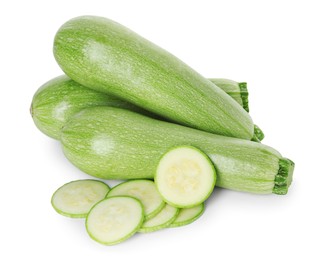 Photo of Fresh whole and cut zucchinis isolated on white, top view