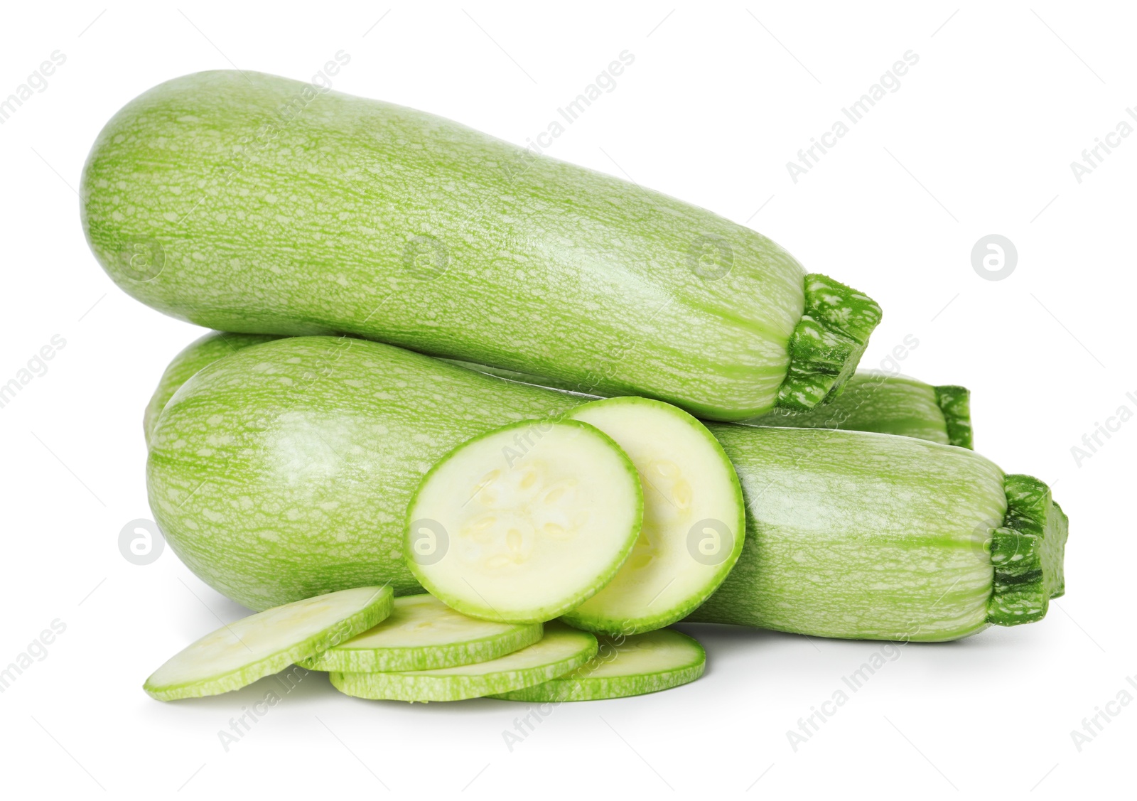 Photo of Fresh whole and cut zucchinis isolated on white