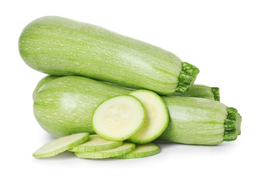 Photo of Fresh whole and cut zucchinis isolated on white