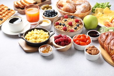 Tasty breakfast. Many different food and drinks on grey textured table