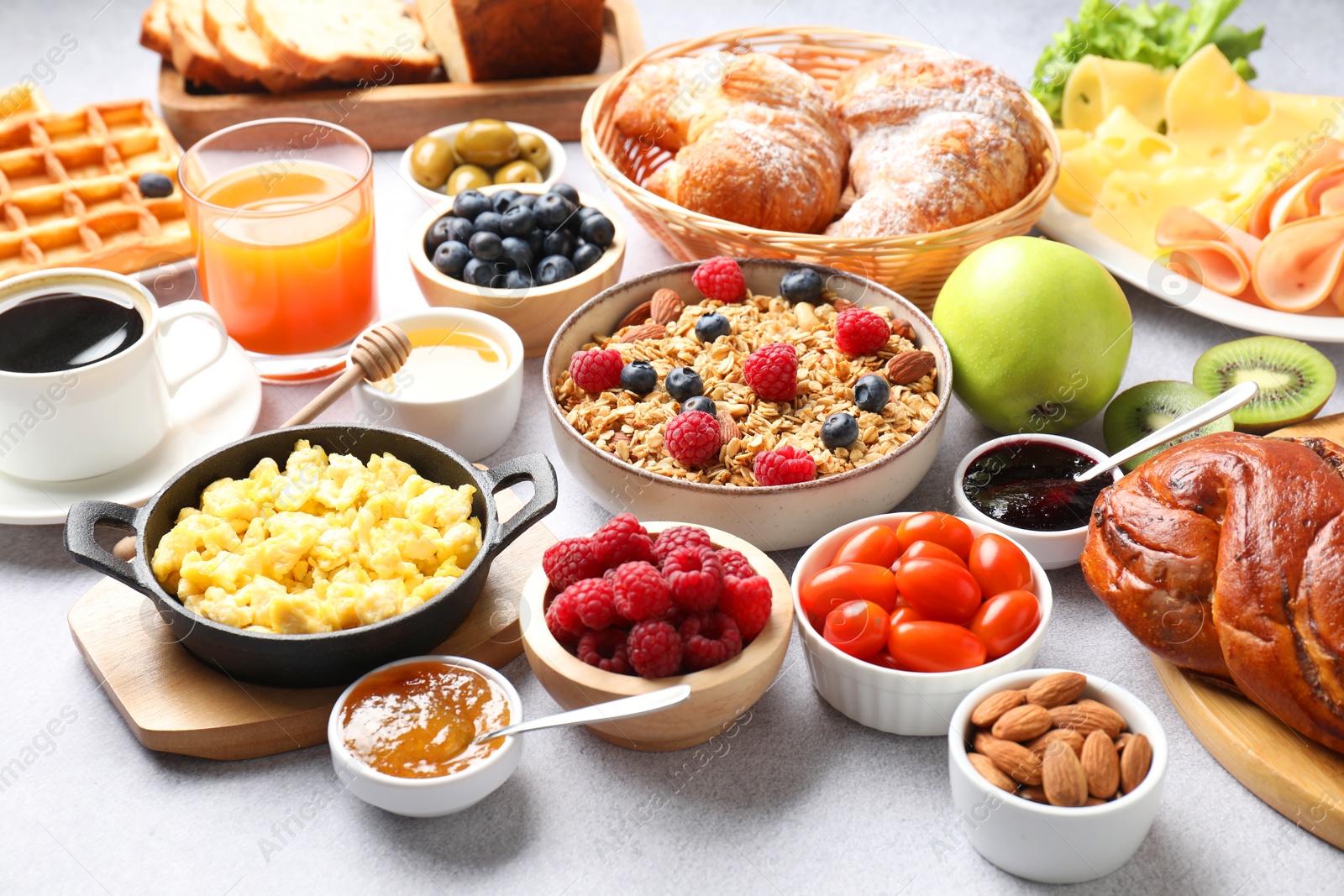 Photo of Tasty breakfast. Many different meals and drinks on grey textured table