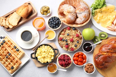 Photo of Tasty breakfast. Flat lay composition with many different food and drinks on grey textured table