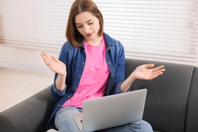 Teenager having video chat via laptop at home. Remote work