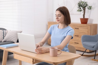 Teenager working with laptop at home. Remote job