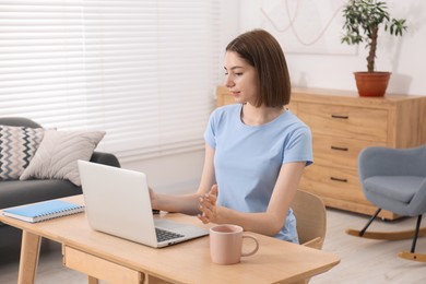 Teenager working with laptop at home. Remote job