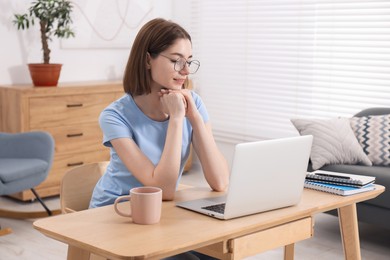 Teenager working with laptop at home. Remote job