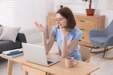 Teenager having video chat via laptop at home. Remote work