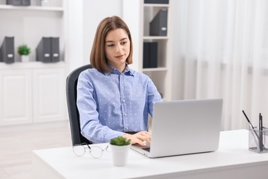 Teenager working with laptop at home. Remote job