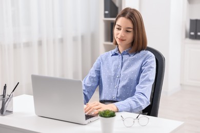 Teenager working with laptop at home. Remote job