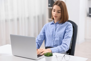 Teenager working with laptop at home. Remote job