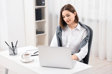 Teenager working with laptop at home. Remote job