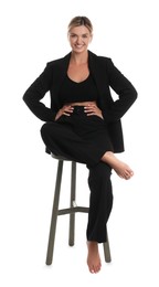 Photo of Beautiful woman in stylish suit on stool against white background