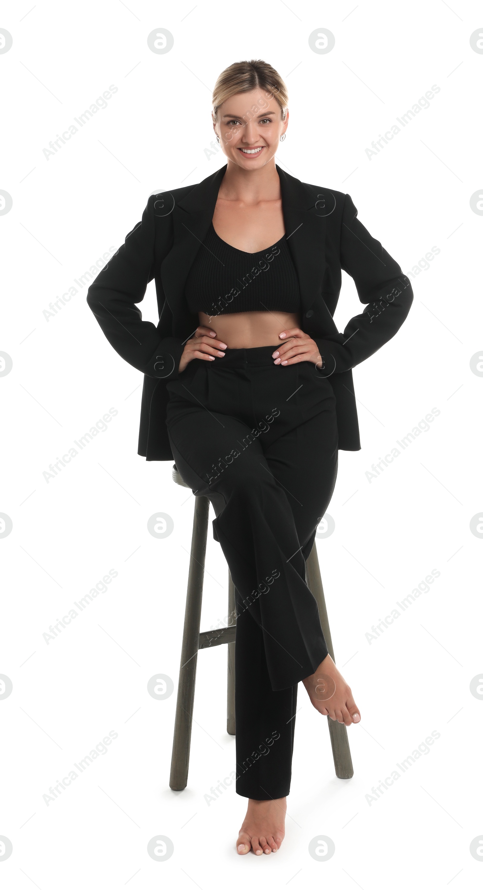 Photo of Beautiful woman in stylish suit on stool against white background