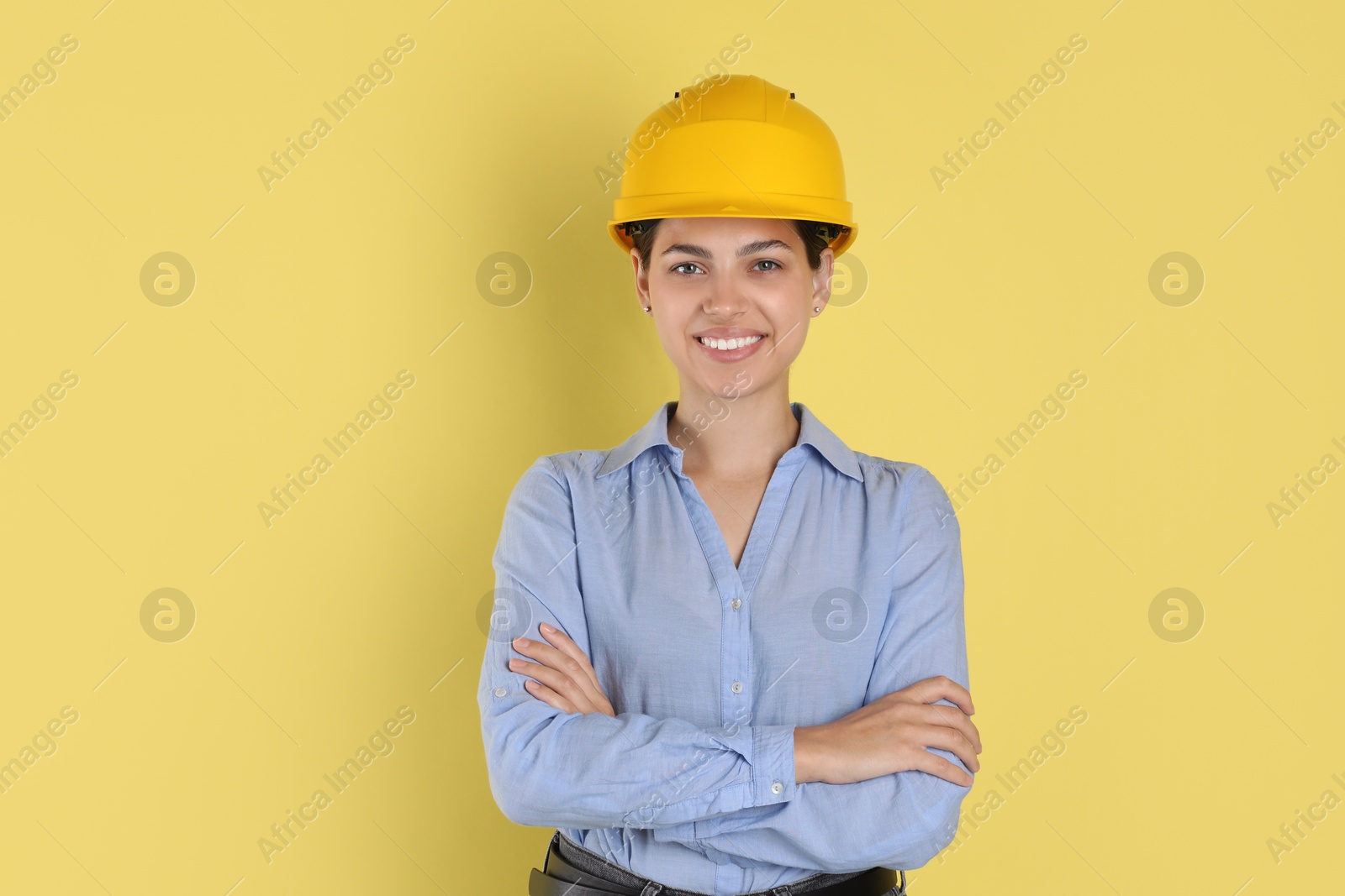 Photo of Engineer in hard hat on yellow background