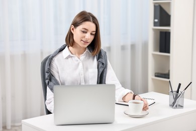 Teenager working with laptop at home. Remote job