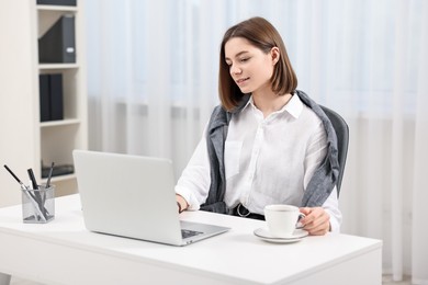 Teenager working with laptop at home. Remote job