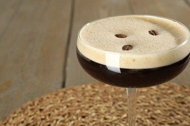 Photo of Glass of fresh coffee cocktail on light table, closeup. Space for text