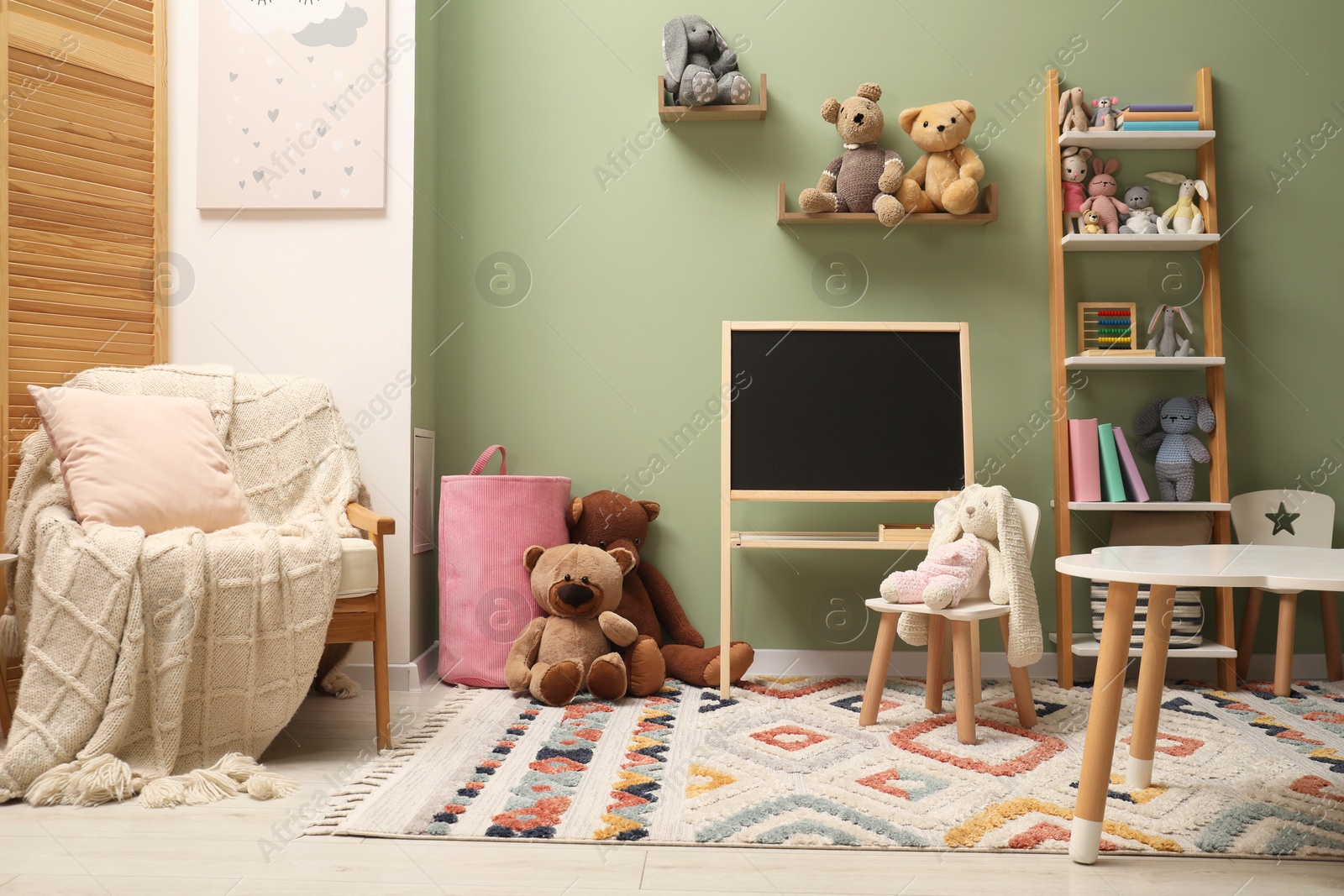 Photo of Stylish child room interior with different toys and furniture