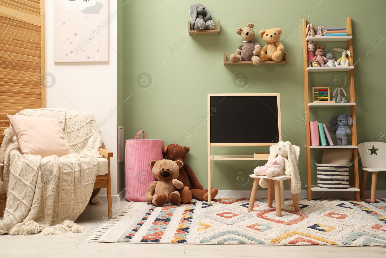 Photo of Stylish child room interior with different toys and furniture