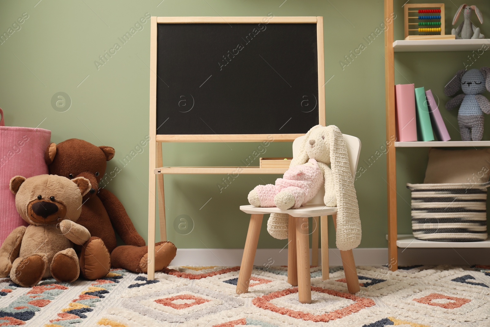 Photo of Stylish child room interior with different toys and furniture