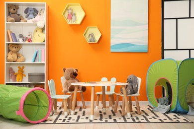 Photo of Stylish child room interior with different toys and furniture