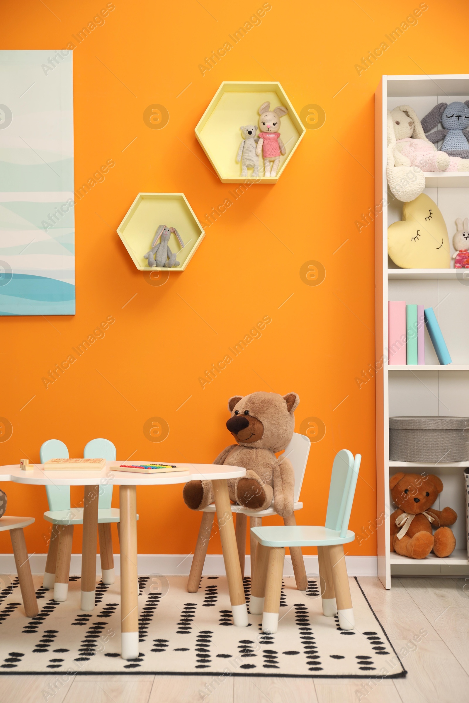 Photo of Stylish child room interior with different toys and furniture