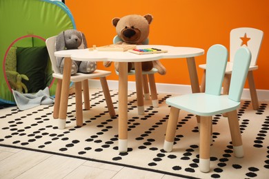 Photo of Stylish child room interior with different toys and furniture