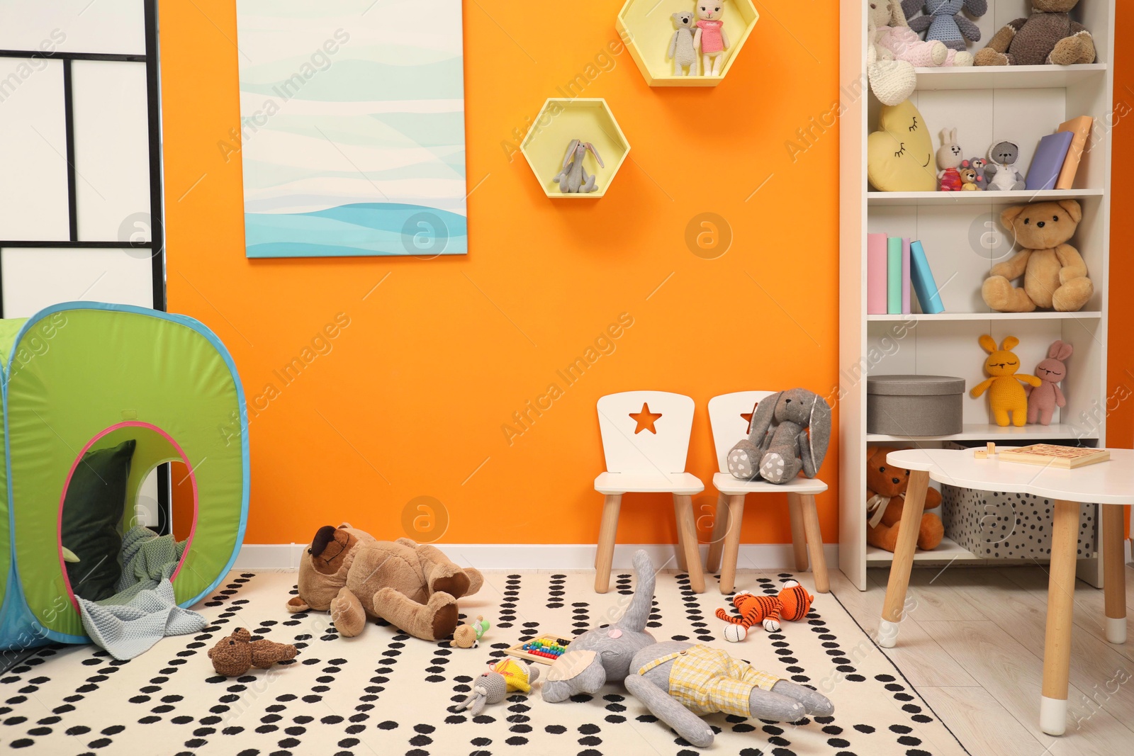 Photo of Stylish child room interior with different toys and furniture