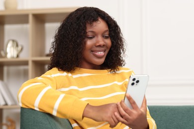 Photo of Beautiful woman using mobile phone at home