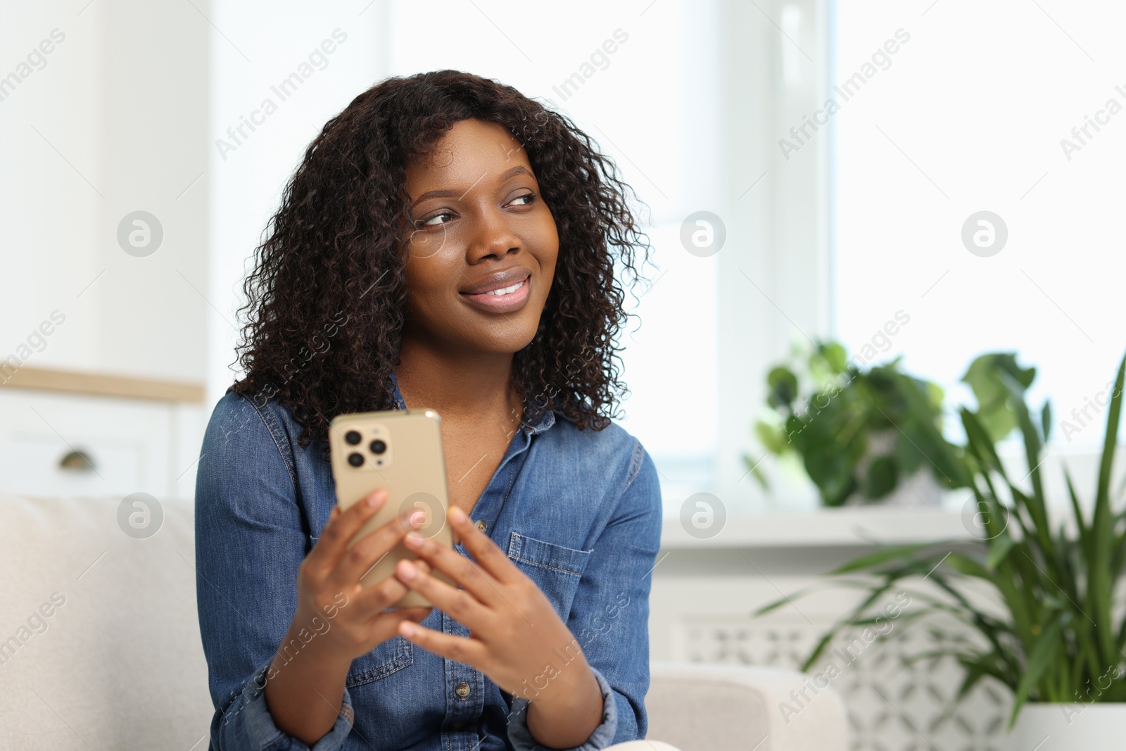 Photo of Beautiful woman with mobile phone at home