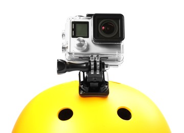 Modern action camera on helmet against white background