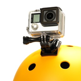 Modern action camera on helmet against white background