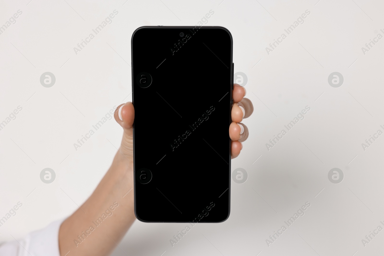 Photo of Woman holding smartphone with blank screen on white background, closeup