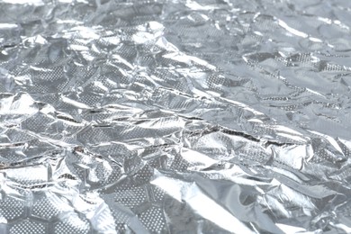 Shiny silver tinfoil surface as background, closeup