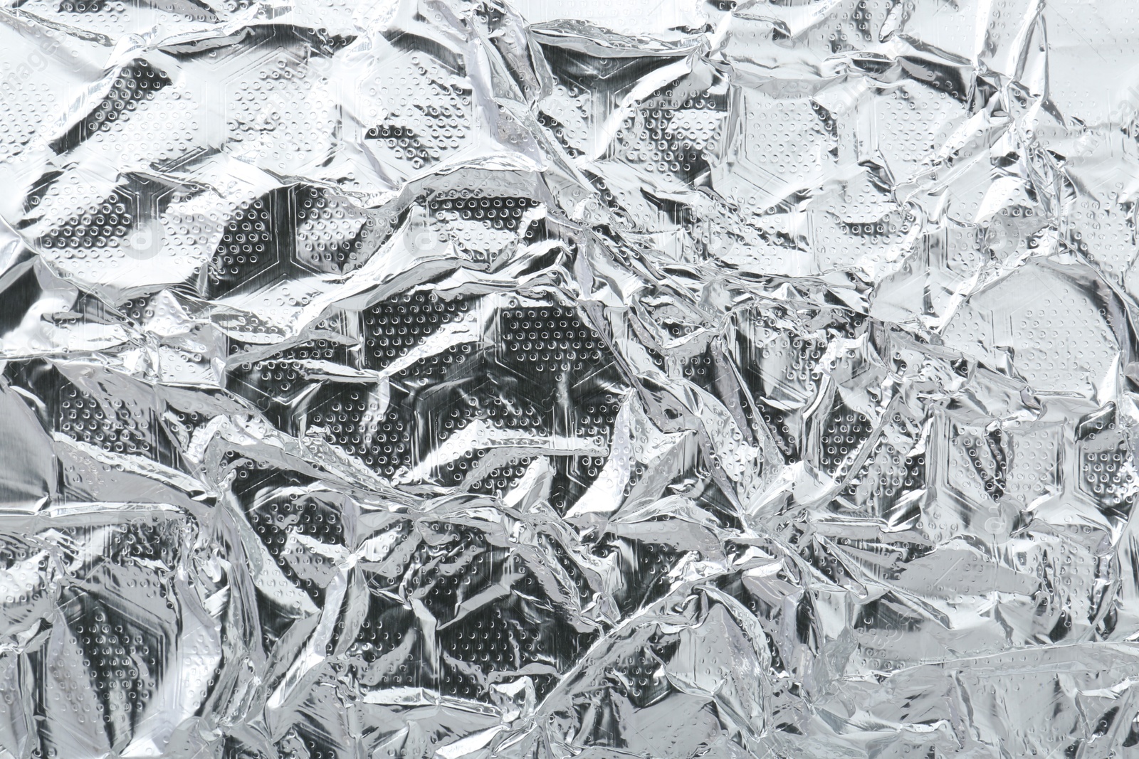 Photo of Shiny silver tinfoil surface as background, top view