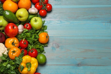 Photo of Different vegetarian products on light blue wooden table, top view. Space for text