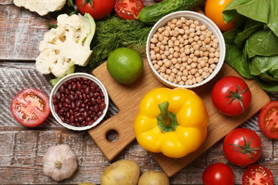 Different vegetarian products on wooden table, top view