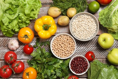 Different vegetarian products on wooden table, top view