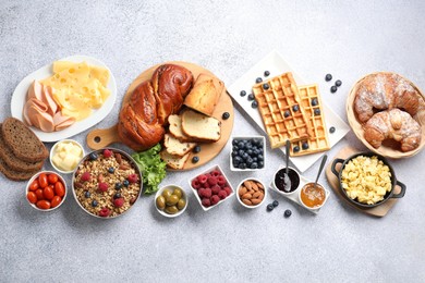 Photo of Tasty breakfast. Flat lay composition with many different food on grey textured table