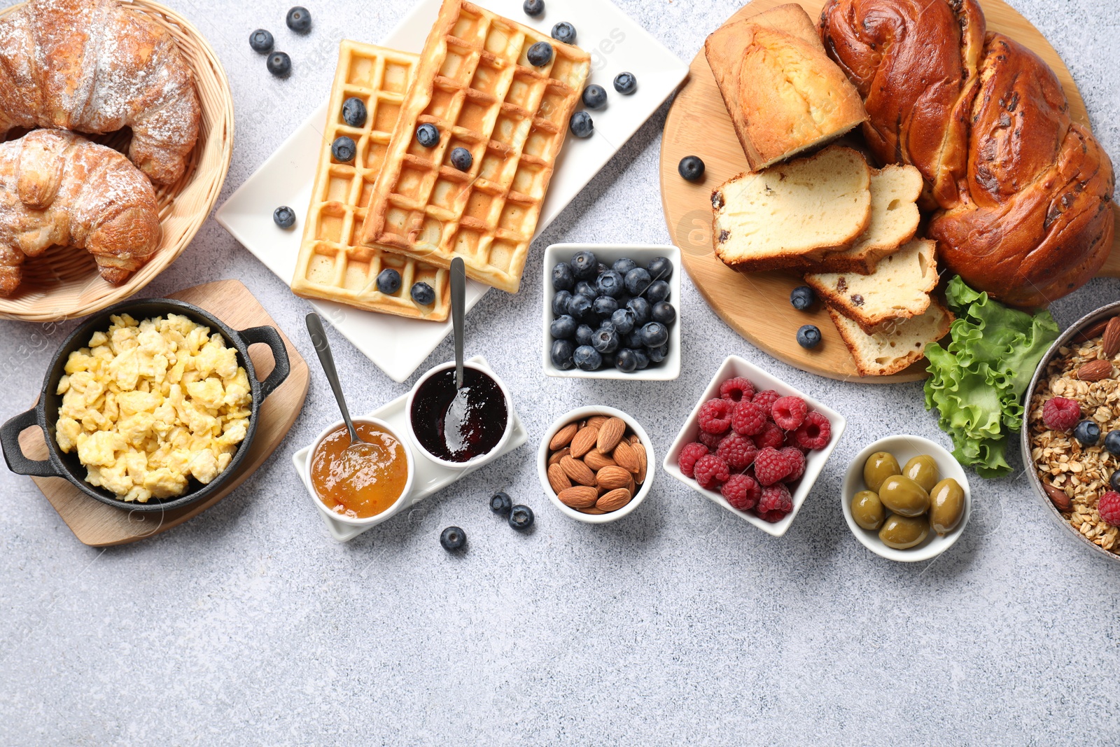 Photo of Tasty breakfast. Flat lay composition with many different food on grey textured table