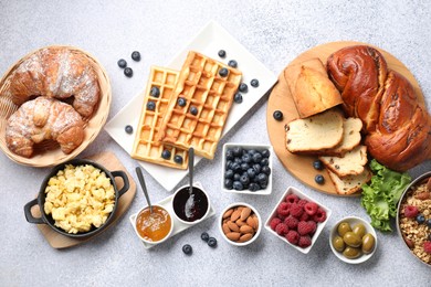 Photo of Tasty breakfast. Flat lay composition with many different food on grey textured table