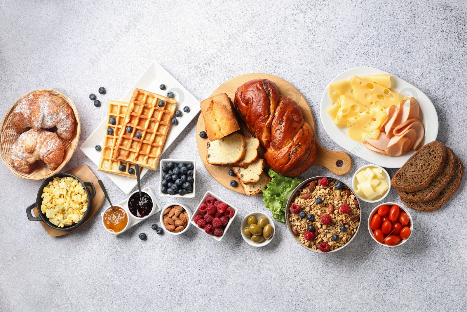 Photo of Tasty breakfast. Flat lay composition with many different food on grey textured table