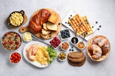 Photo of Tasty breakfast. Flat lay composition with many different food on grey textured table