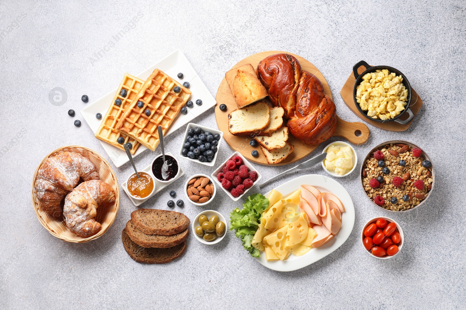 Photo of Tasty breakfast. Flat lay composition with many different food on grey textured table