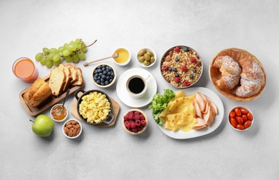 Tasty breakfast. Flat lay composition with many different food and drinks on grey textured table